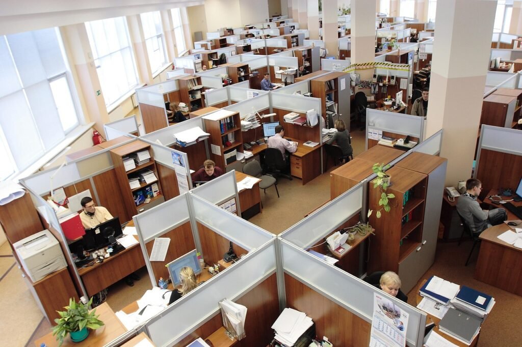 An open floor office with employees in their cubicles